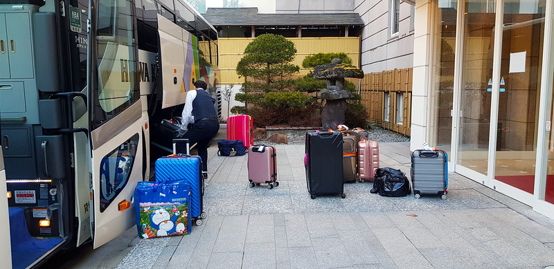 Suitcases being unloaded at a Japanese hotel. Editorial credit: Nattasak Buranasri / Shutterstock.com