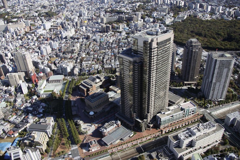 Aerial view of the Ebisu area of Tokyo, with skyscrapers and train lines, and other buildings