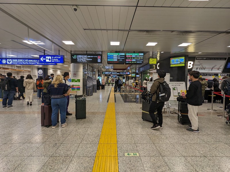 The subway passage to Narita Airport's Terminal 2, crowded with numerous tourists