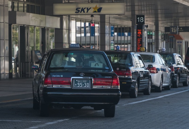 A queue of taxis wait for passengers at a rank outside Haneda International Airport, Tokyo