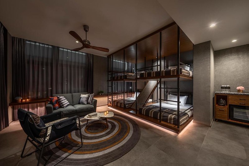 Loft room in The Lively Tokyo Azabujuban hotel with four large bunks and stylish living area