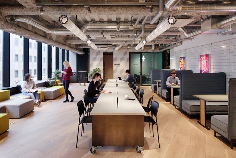 The common working area in The Millennials Shibuya hotel, Tokyo, with collective desk area for working and booths for meetings