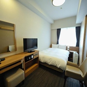 Compact double room with desk and television in the Dormy Inn Akihabara hotel, Tokyo, Japan