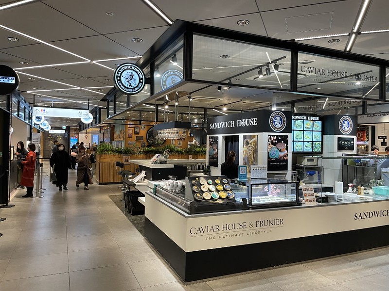 Shoppers browse at different food counters in the basement food floor of the Tokyu Plaza shopping and dining complex in Tokyo, Japan