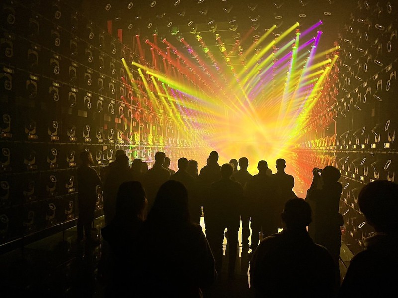 The teamLab Borderless Light Sculpture room has hundreds of swivelling light beams creating colourful fractal, vortex-like patterns