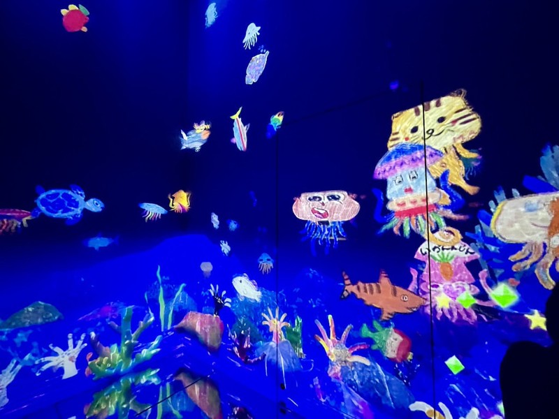 Visitors’ drawings in the Sketch Ocean part of teamLab Borderless are projected onto the wall