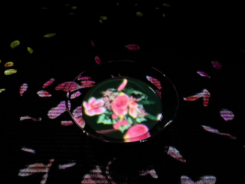 Digital flowers bloom in a cup in the teamLab Borderless EN Tea House