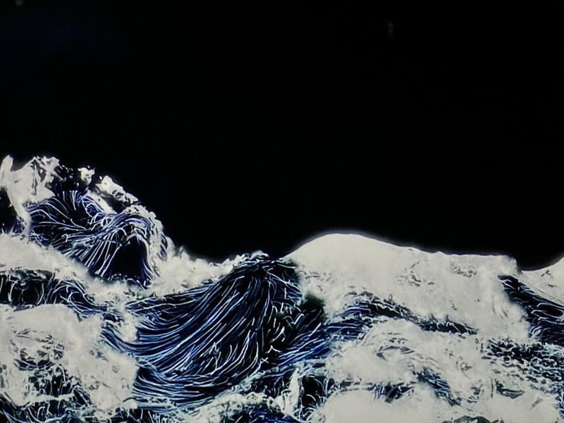 Black waves break in one of the teamLab Borderless artworks