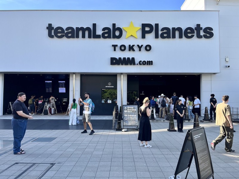 People on the forecourt outside the main entrance to the teamLab Planets building in Tokyo, Japan