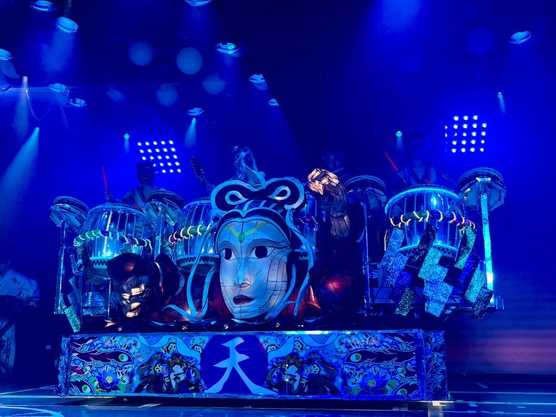 A traditional blue Japanese float with taiko drummers and glow sticks at Samurai Restaurant Time