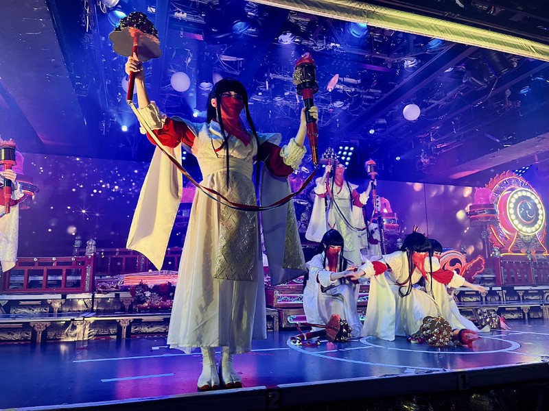 Characters on stage at Samurai Restaurant Time dressed as veiled handmaidens in the Court of Hell