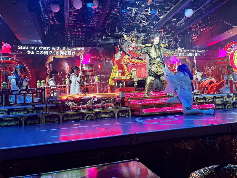 Onstage at Samurai Restaurant Time, the character Musashi challenges the King of Hell to a sword fight