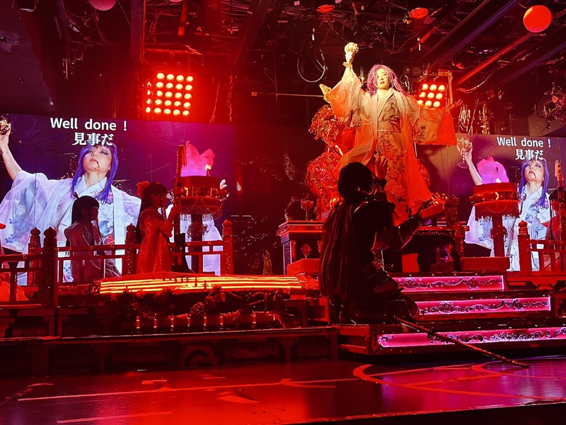 The character Sagara Yukinojo drinks the King of Hell’s blood from a cup carved from his skull  onstage at Samurai Restaurant Time