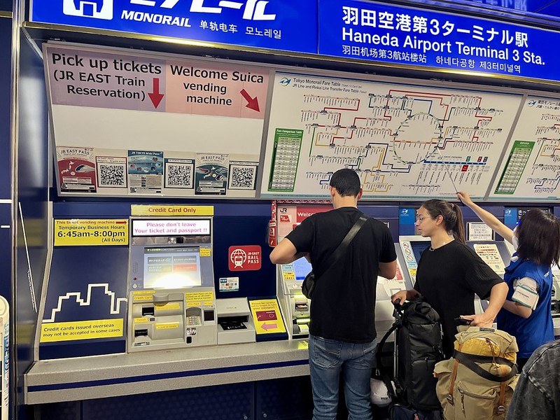 People using the Welcome Suica IC card vending machines at Haneda Airport People using the Welcome Suica IC card vending machines at Haneda Airport